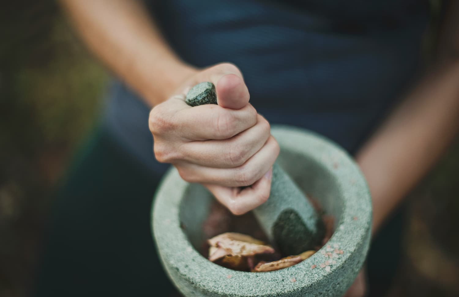 grinding Chinese herbal medicine in a pestle and motor